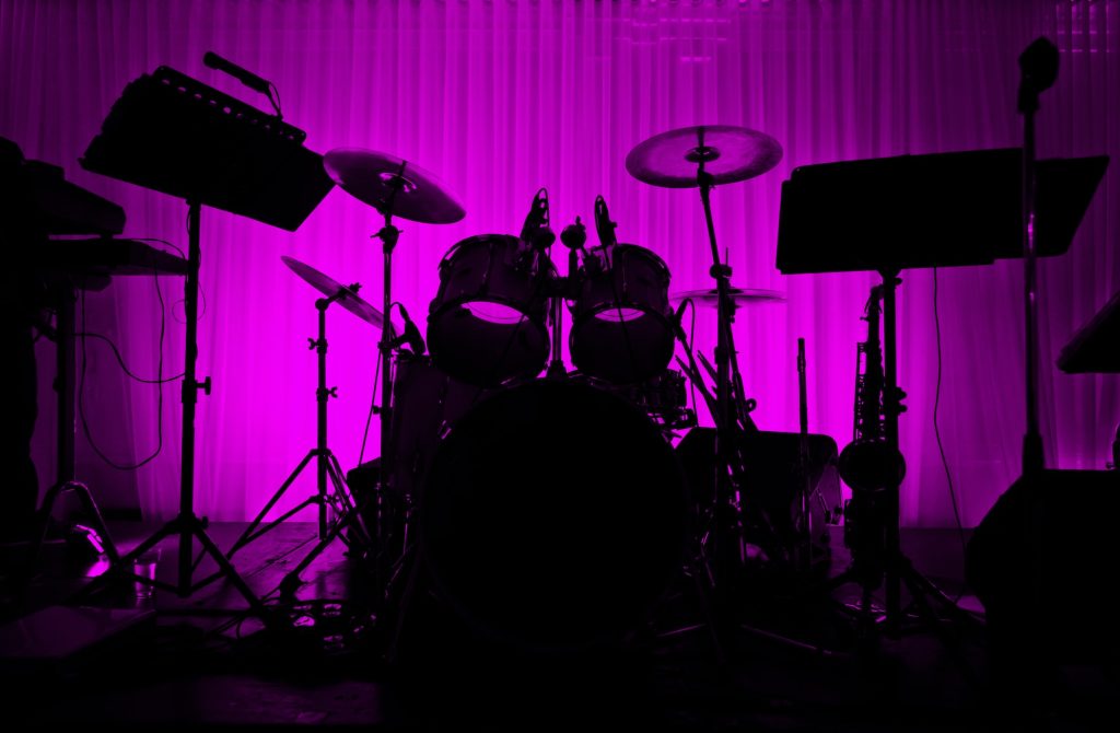 Drum in silhouette with no musician.